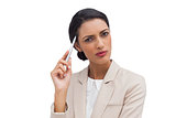 Thoughtful businesswoman holding a pen