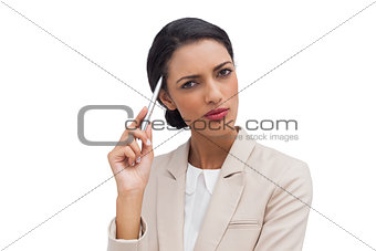 Thoughtful businesswoman holding a pen