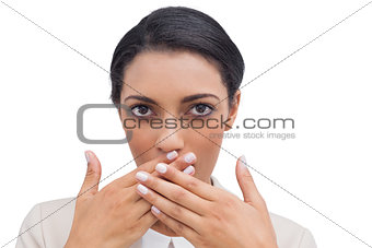 Shocked businesswoman putting her hand in front of her mouth