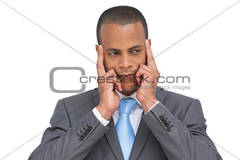 Young businessman putting his fingers on his temples