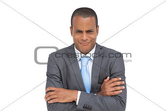 Doubtful businessman with arms crossed