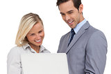 Business people looking at laptop and smiling