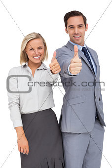 Business people showing thumbs up