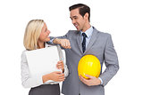 Architects with plans and hard hat smiling at each other