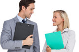 Smiling business people looking at each other with folders
