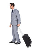 Young businessman with glasses holding a trolley
