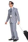 Smiling businessman walking with his suitcase