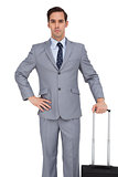 Businessman waiting while holding his suitcase