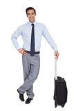 Handsome smiling businessman standing with his suitcase