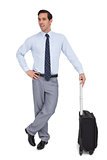 Charismatic businessman standing with his suitcase