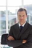 Confident businessman with arms folded