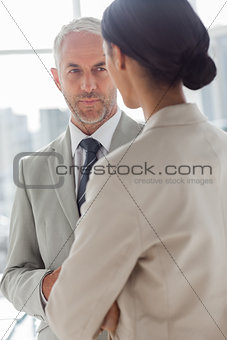 Concentrated businessman listening to colleague
