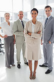 Attractive businesswoman standing in front of colleagues