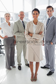 Attractive businesswoman standing in front of colleagues