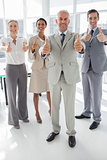 Group of business people giving thumbs up