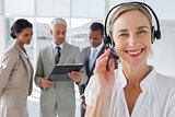 Close up of smiling woman standing with a headset