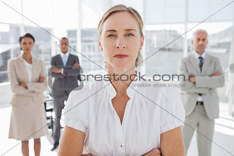 Serious businesswoman standing with arms folded
