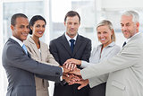 Group of business people piling up their hands together