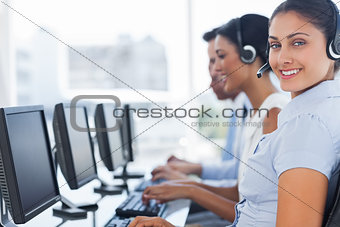 Smiling call center employee looking at camera
