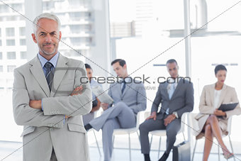 Serious businessman standing in a waiting room