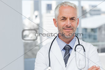 Doctor standing with arms folded