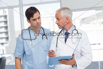 Doctors talking about a file