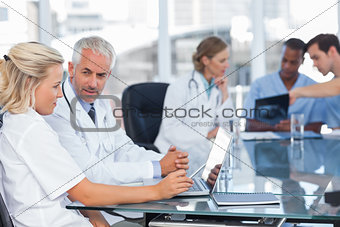 Two doctors using laptop