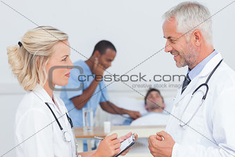 Smiling doctors speaking together