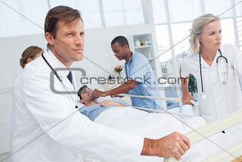 Doctors pushing the bed of a patient