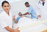 Nurse pushing bed of patient in emergency