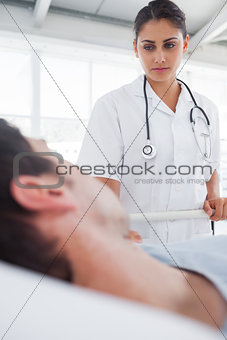 Serious nurse taking care of a patient