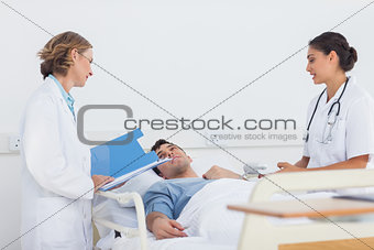 Doctors explaining the symptoms to a patient