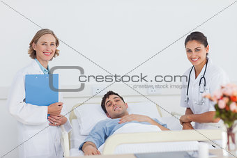Doctors and patient looking at the camera
