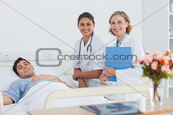 Patient and doctors looking at the camera