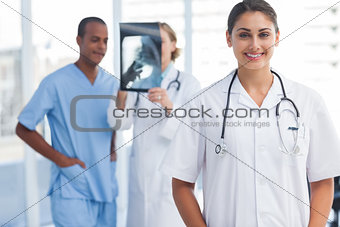 Woman doctor standing in a bright hospital