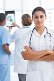 Serious woman doctor with arms crossed looking at the camera