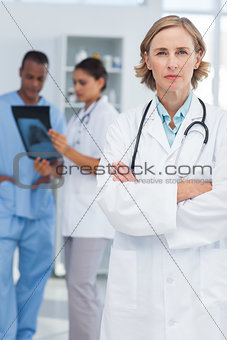 Serious doctor with arms folded