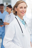 Smiling woman doctor in front of medical team