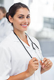 Attractive woman doctor holding her stethoscope