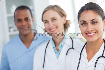 Three smiling doctors looking at the camera