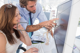 Man pointing something to his partner on screen