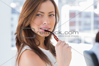 Attractive woman biting her glasses