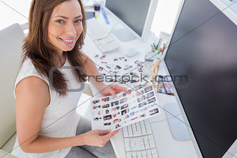 Photo editor holding contact sheet