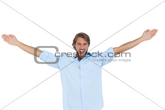 Handsome man shouting with his hands raised