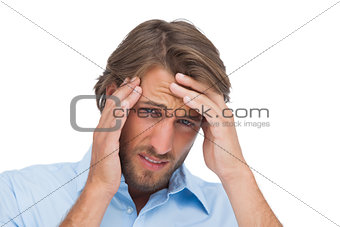 Tanned man having a strong headache