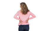 Blonde woman having a back ache and holding her back