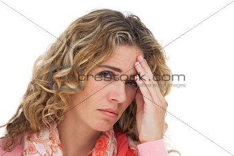 Blonde woman suffering with headache and holding her head