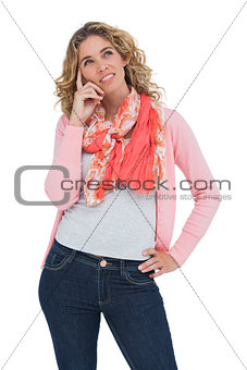 Woman posing and smiling while touching her head