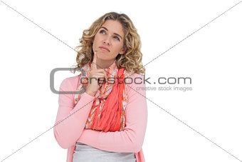 Thoughtful blonde woman posing and raising one eyebrow