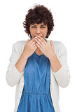Astonished brunette woman putting hands on mouth